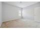 Neutral bedroom with beige carpet, a window, and a closet at 7434 Absinth Dr, Atlanta, GA 30349