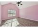 Pink bedroom featuring wood-style flooring, a vaulted ceiling, and natural light at 7434 Absinth Dr, Atlanta, GA 30349