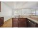 Kitchen with granite counters, stainless steel appliances and view to a light filled living area at 7434 Absinth Dr, Atlanta, GA 30349