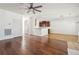 Open floorplan with hardwood flooring leading to a kitchen bar and dining area at 7434 Absinth Dr, Atlanta, GA 30349