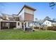 Landscaped backyard featuring a modern home with a hot tub, patio, and second-story balcony at 1045 Shepherds Ne Ln, Atlanta, GA 30324