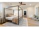 Bedroom with four-poster bed, area rug, modern fan, and adjacent closet at 1045 Shepherds Ne Ln, Atlanta, GA 30324