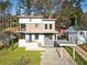 Contemporary two-story home with a modern exterior, manicured lawn, and covered parking space, set in a lush landscape at 1045 Shepherds Ne Ln, Atlanta, GA 30324