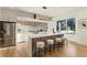 Bright kitchen with stainless steel appliances, center island and seating, and light wood floors at 1045 Shepherds Ne Ln, Atlanta, GA 30324