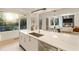 Bright kitchen with stainless steel appliances and island sink open to living area with fireplace at 1045 Shepherds Ne Ln, Atlanta, GA 30324