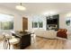 Bright open layout with hardwood floors, modern fireplace, and large windows overlooking the outdoors at 1045 Shepherds Ne Ln, Atlanta, GA 30324
