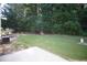 Lush backyard with mature trees surrounding a well-manicured lawn at 2426 Fairlie Dr, Duluth, GA 30096
