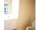 Bathroom featuring white vanity, toilet, and mirror; bathroom shows standard-height toilet at 2426 Fairlie Dr, Duluth, GA 30096