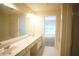 Bathroom featuring double sinks, vanity, and bathtub, with an open doorway to bedroom at 2426 Fairlie Dr, Duluth, GA 30096