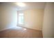 Well-lit bedroom featuring a large window and soft carpeting at 2426 Fairlie Dr, Duluth, GA 30096