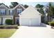 Charming townhouse featuring a two-car garage and manicured landscaping at 2426 Fairlie Dr, Duluth, GA 30096