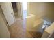 Hallway view showing staircase and doorway to a bathroom with access to an additional room at 2426 Fairlie Dr, Duluth, GA 30096