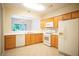 Well-lit kitchen featuring tile floors, wood cabinets, and modern appliances at 2426 Fairlie Dr, Duluth, GA 30096