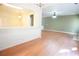 Spacious living room with hardwood flooring, neutral paint, and views into the adjacent kitchen at 2426 Fairlie Dr, Duluth, GA 30096