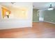 Open-concept living room featuring hardwood floors and decorative wainscoting looking into the kitchen at 2426 Fairlie Dr, Duluth, GA 30096