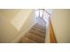 Carpeted stairs leading to the upper level, featuring white banisters and a natural wood handrail at 2426 Fairlie Dr, Duluth, GA 30096