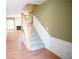 Carpeted staircase with wood railing and white trim; staircase leads to the upper level of the home at 2426 Fairlie Dr, Duluth, GA 30096