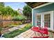 Serene backyard patio with lush landscaping, stone pathway, and vibrant red table set near the house at 1912 Hosea L Williams Ne Dr # 1, Atlanta, GA 30317
