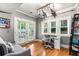 Sunlit office with hardwood floors, French doors, and versatile furniture options at 1912 Hosea L Williams Ne Dr # 1, Atlanta, GA 30317