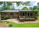 Brick home featuring a screened-in porch and a wooden deck overlooking the backyard at 272 Creek Sw Ct, Marietta, GA 30064