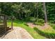 Lush backyard featuring manicured landscaping and a stone pathway at 272 Creek Sw Ct, Marietta, GA 30064