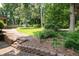 Beautiful backyard features landscaping and stone steps leading up to the home at 272 Creek Sw Ct, Marietta, GA 30064