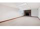 Spacious basement featuring a brick fireplace and neutral carpet at 272 Creek Sw Ct, Marietta, GA 30064