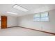 Large basement with neutral carpet, recessed lighting, and natural light from the window at 272 Creek Sw Ct, Marietta, GA 30064