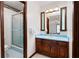 Bathroom featuring dark wood cabinets, a light blue countertop, and a shower with glass doors at 272 Creek Sw Ct, Marietta, GA 30064