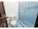 Close up of a clean bathroom including a white toilet and shower with frosted glass doors at 272 Creek Sw Ct, Marietta, GA 30064