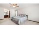 Bright bedroom featuring a ceiling fan and an ensuite bathroom with a dark wood vanity at 272 Creek Sw Ct, Marietta, GA 30064