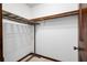 Walk-in closet offering convenient storage with metal shelving and a wooden closet rod at 272 Creek Sw Ct, Marietta, GA 30064