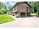 Two-story brick house featuring a two-car garage and mature trees at 272 Creek Sw Ct, Marietta, GA 30064
