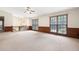 Open living room featuring a ceiling fan and lots of natural light from several large windows at 272 Creek Sw Ct, Marietta, GA 30064