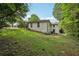 Exterior elevation of home's backyard with lush green grass at 3422 Maplehurst Dr, Decatur, GA 30032