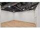 Open unfinished basement with wooden floors and bright lighting at 3422 Maplehurst Dr, Decatur, GA 30032