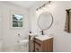 Charming bathroom featuring a modern vanity, round mirror, and brushed nickel fixtures at 3422 Maplehurst Dr, Decatur, GA 30032
