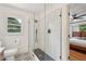 Bathroom showcasing an updated tiled shower with glass door and patterned tile floors at 3422 Maplehurst Dr, Decatur, GA 30032