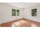 Bright bedroom featuring hardwood floors, neutral walls, and two windows allowing for ample natural light at 3422 Maplehurst Dr, Decatur, GA 30032