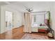 Bedroom featuring hardwood floors, a ceiling fan, and easy access to an en-suite bathroom at 3422 Maplehurst Dr, Decatur, GA 30032