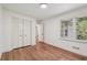 Comfortable bedroom with hardwood floors, a closet, and natural light from the window at 3422 Maplehurst Dr, Decatur, GA 30032