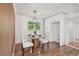 Cozy dining area with hardwood floors, a modern light fixture, and a large window with views of the backyard at 3422 Maplehurst Dr, Decatur, GA 30032