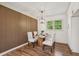 Elegant dining room featuring wood-look accent wall, pendant lighting, and hardwood floors, perfect for entertaining at 3422 Maplehurst Dr, Decatur, GA 30032