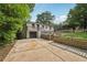 Two-story home featuring a deck and a garage nestled in a green surrounding at 3422 Maplehurst Dr, Decatur, GA 30032