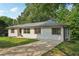 Charming house with a driveway and grassy yard at 3422 Maplehurst Dr, Decatur, GA 30032