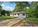 One-story home with a lush green lawn and long driveway at 3422 Maplehurst Dr, Decatur, GA 30032