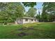 Charming single-story home with a lush green lawn and mature trees surrounding the property at 3422 Maplehurst Dr, Decatur, GA 30032