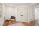 Hallway area featuring hardwood floors, white walls, and a closet for optimal storage space at 3422 Maplehurst Dr, Decatur, GA 30032