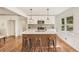 Updated kitchen featuring white cabinets, a spacious island with seating, and hardwood floors, perfect for cooking and dining at 3422 Maplehurst Dr, Decatur, GA 30032