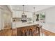 Bright kitchen with an island, pendant lighting, stainless steel appliances and warm wood floors at 3422 Maplehurst Dr, Decatur, GA 30032